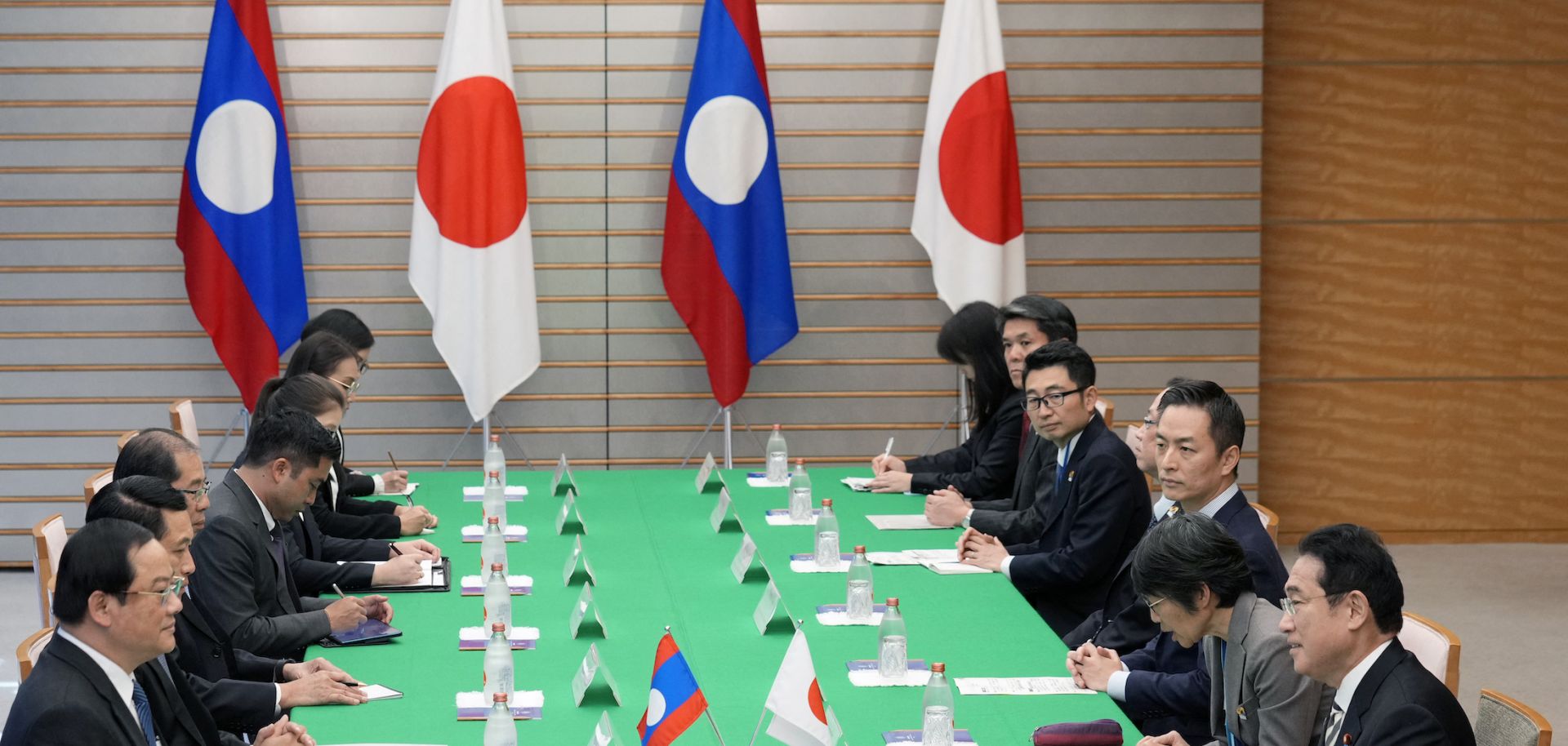 Japan's Prime Minister Fumio Kishida (R) delivers an opening address at the start of a bilateral meeting with Laos' Prime Minister Sonexay Siphandone (L) at the prime minister's official residence in Tokyo, Japan, on Dec. 16, 2023.