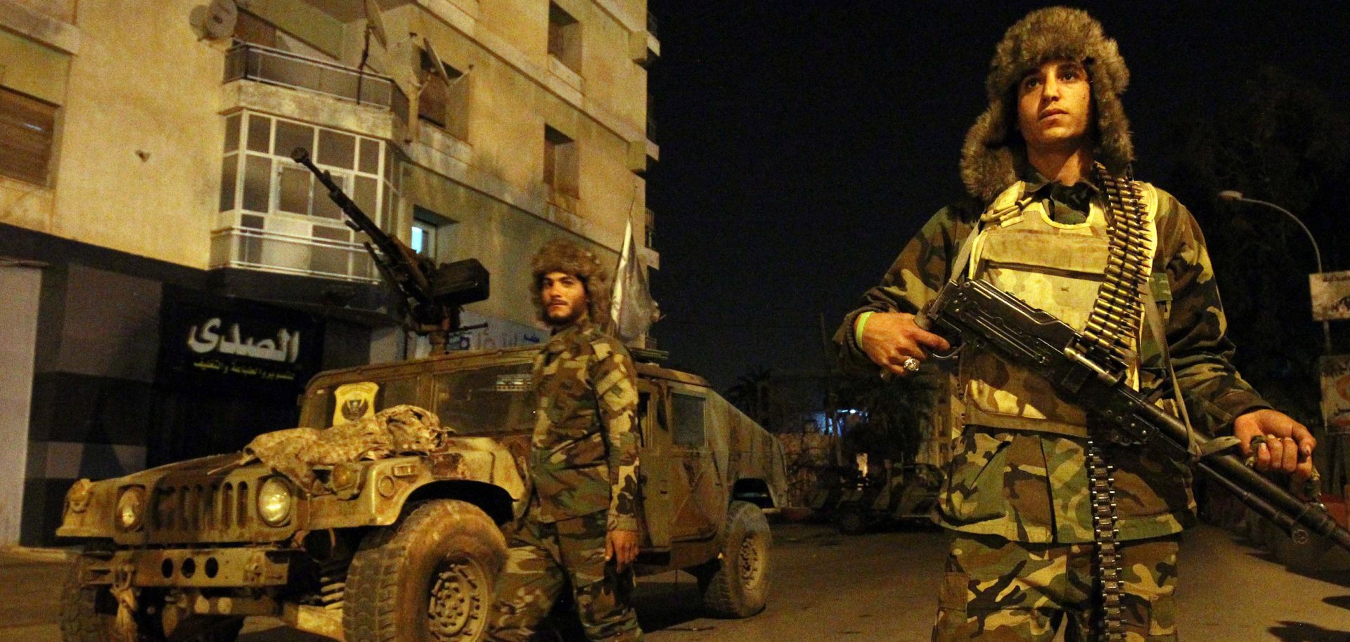 Fighters with the self-styled Libyan National Army, commanded by Khalifa Hifter, patrol the roads leading into Benghazi on Feb. 7, 2018.