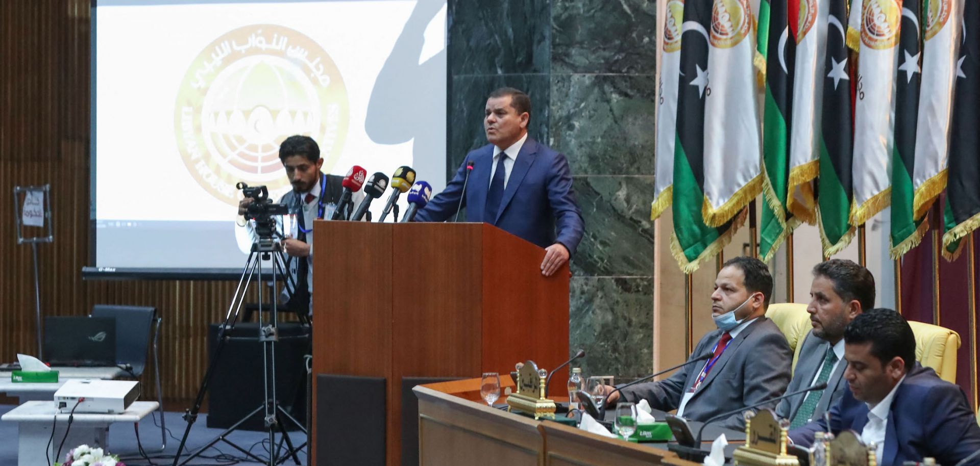 Libyan Prime Minister-designate Abdul Hamid Dbeibah addresses lawmakers during the first reunited parliamentarian session on March 9, 2021, in the coastal city of Sirte, east of the Libyan capital of Tripoli.