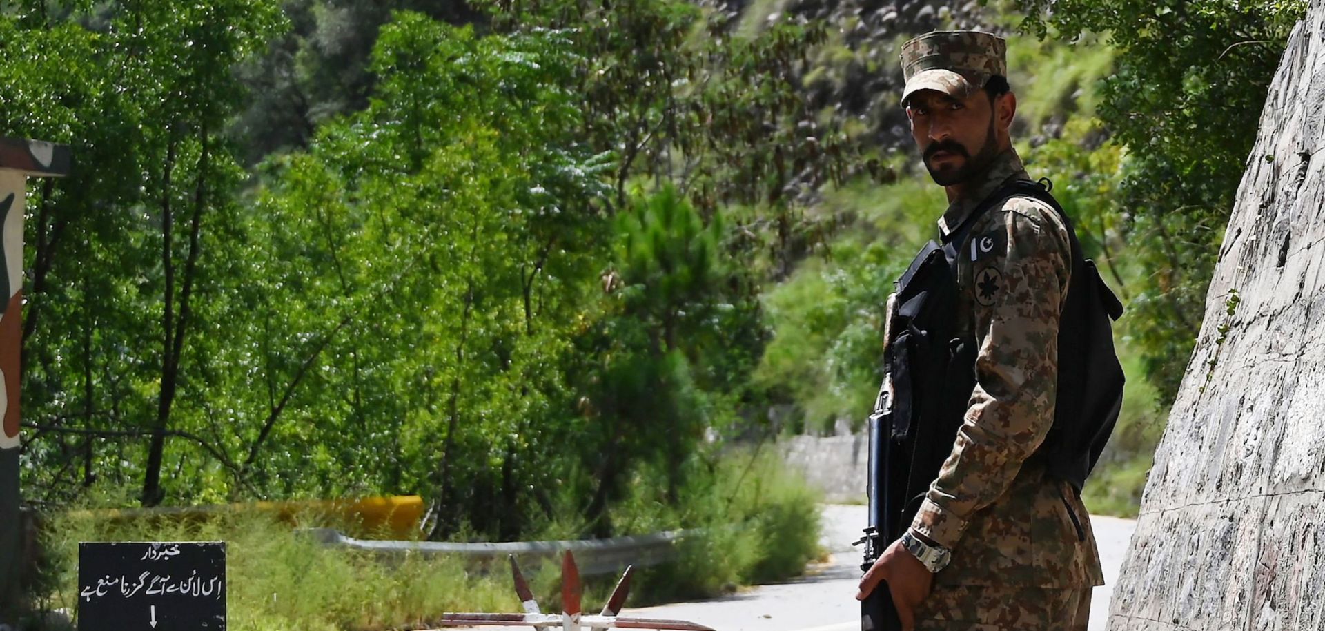 This photo shows a lone Pakistani soldier patrolling the Line of Control, the de facto border between Pakistan and India, in Pakistan-administered Kashmir on Aug. 29, 2019. 