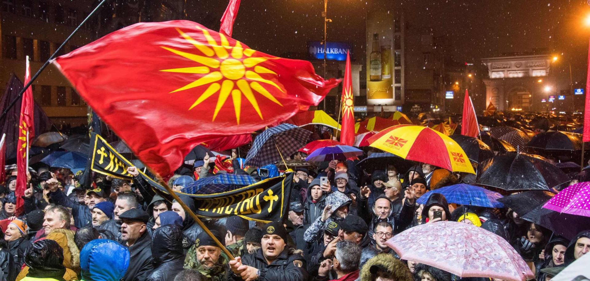 Demonstrators hold Macedonian flags during a protest
