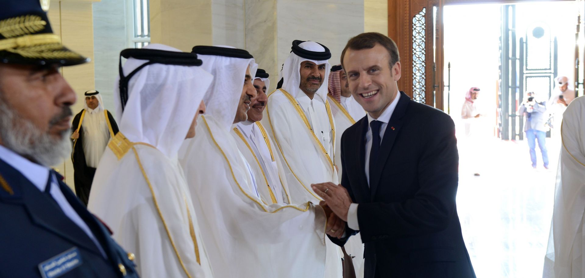 Qatari officials greet French President Emmanuel Macron (R) on his recent visit to Doha in December 2017.
