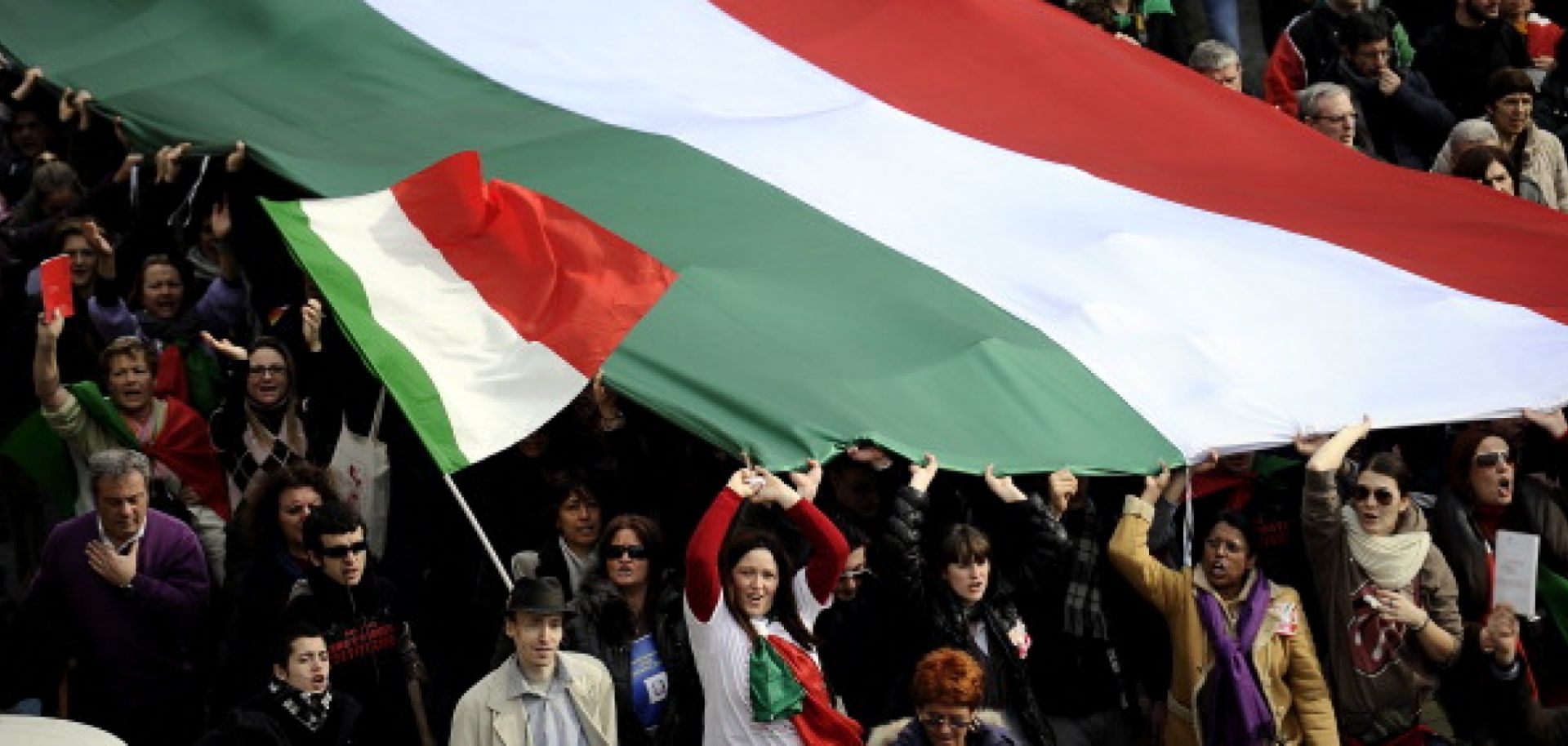 Protesters in Rome wave Italian flags.