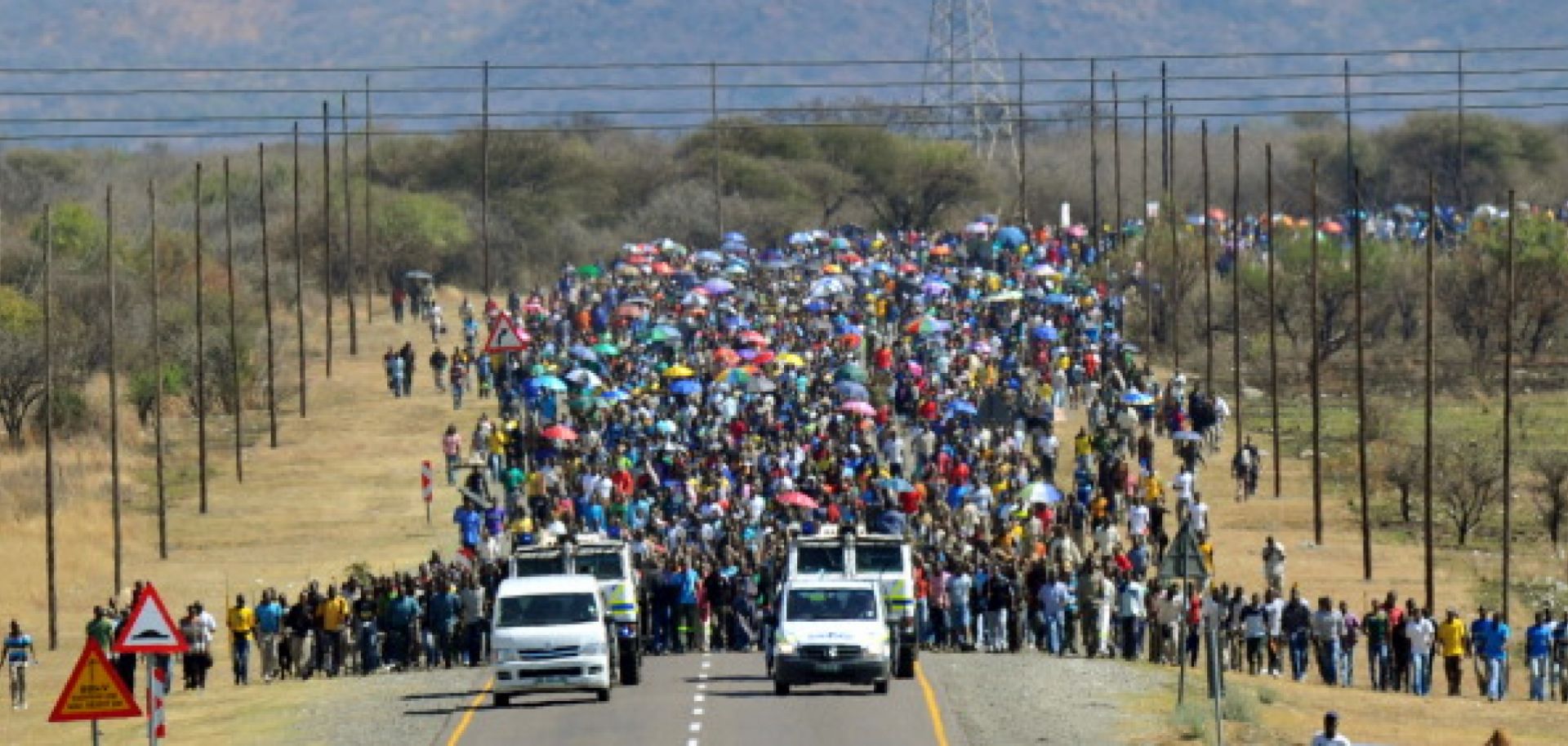Thousands of South African mine workers walk to the Lonmin mine in Marikana on Sept. 10.