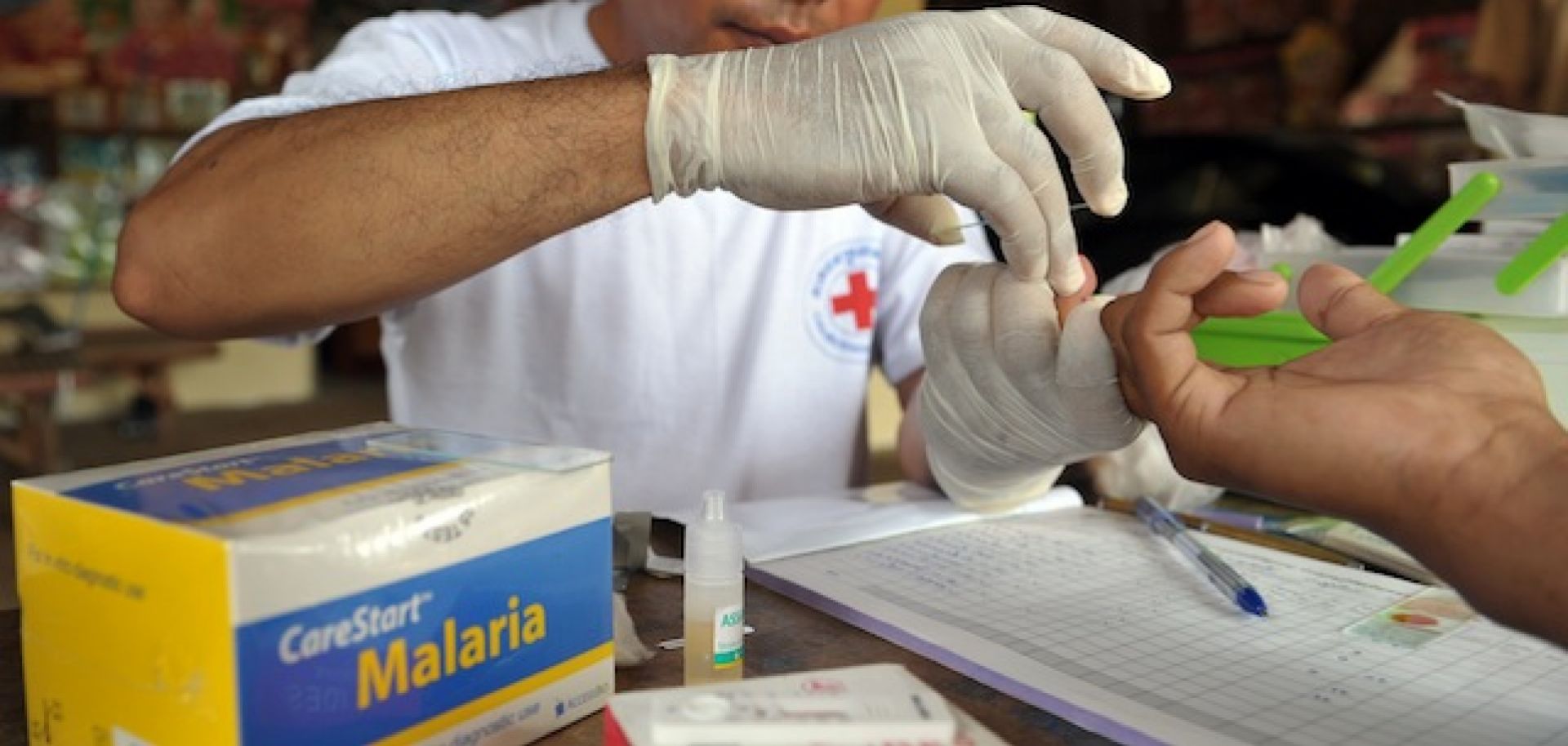 A village malaria worker checks a blood test at his home in Cambodia's Pailin province. While there are numerous ongoing efforts to prevent malaria, an early trial of a new vaccine is showing promise. If effective, it would be a boon to many emerging economies.