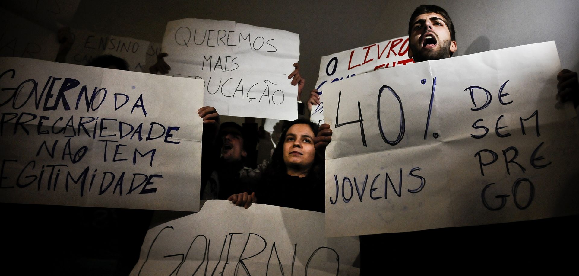 Portuguese students hold signs, including one that reads "Youth unemployment 40 percent," during a protest in Lisbon on Feb. 27.
