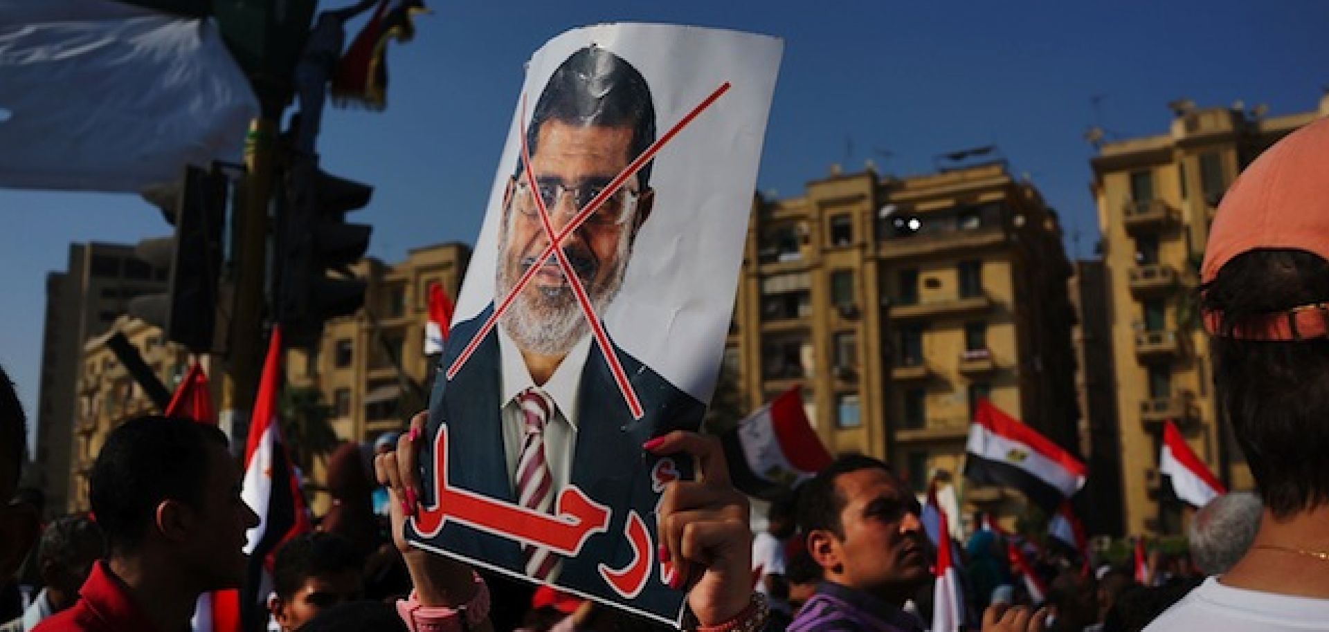 A protester waves an anti-Morsi poster in Tahrir Square on July 3