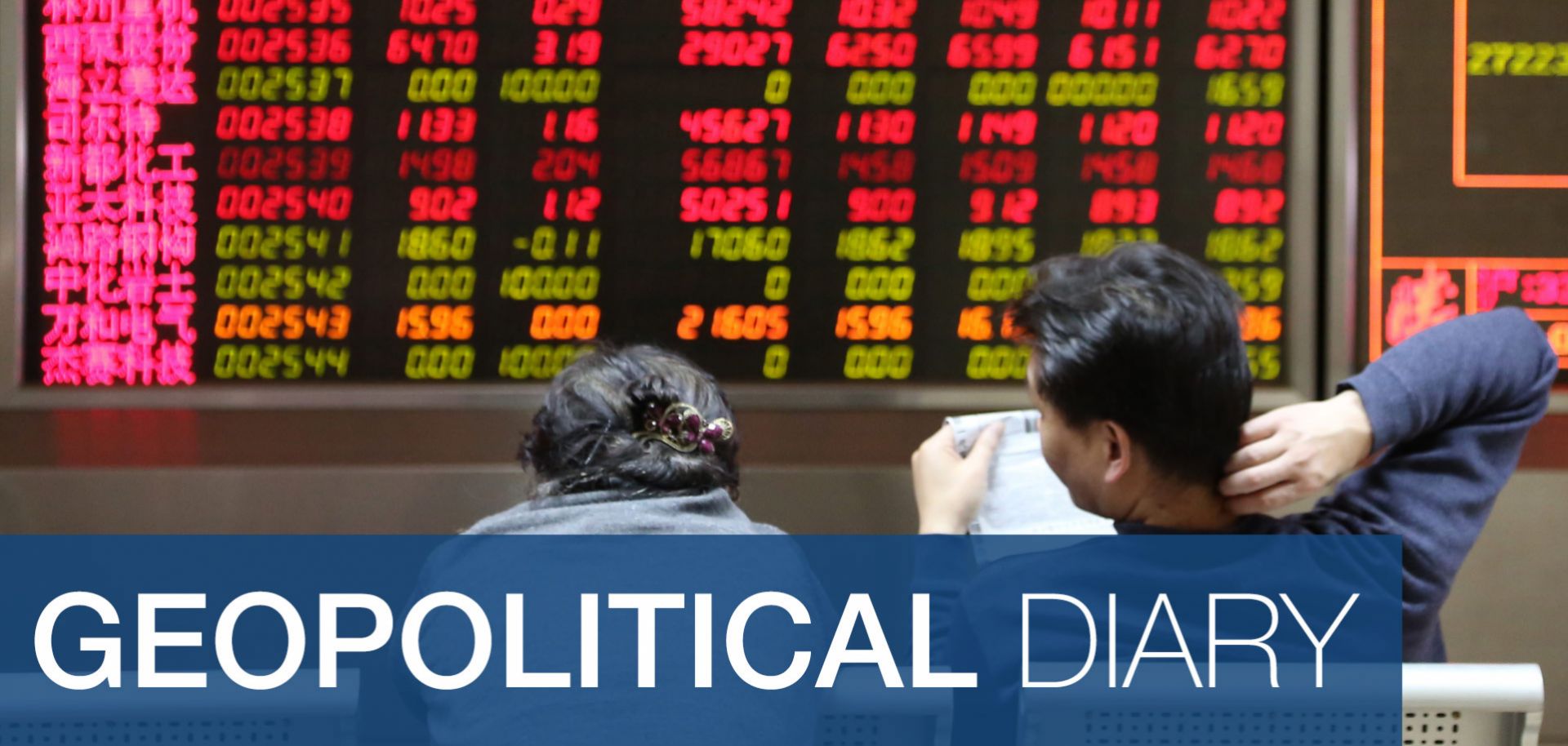 Investors observe stock market data at an exchange hall in Beijing.