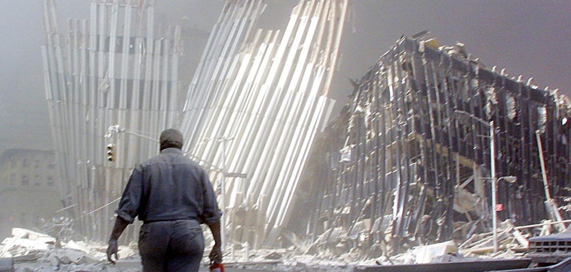 A man walks through the rubble left by the collapse of the south tower of the World Trade Center on Sept. 11, 2001. 
