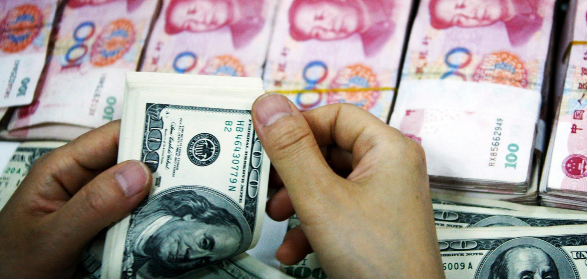 An employee counts money at a branch of Industrial and Commercial Bank of China Limited.