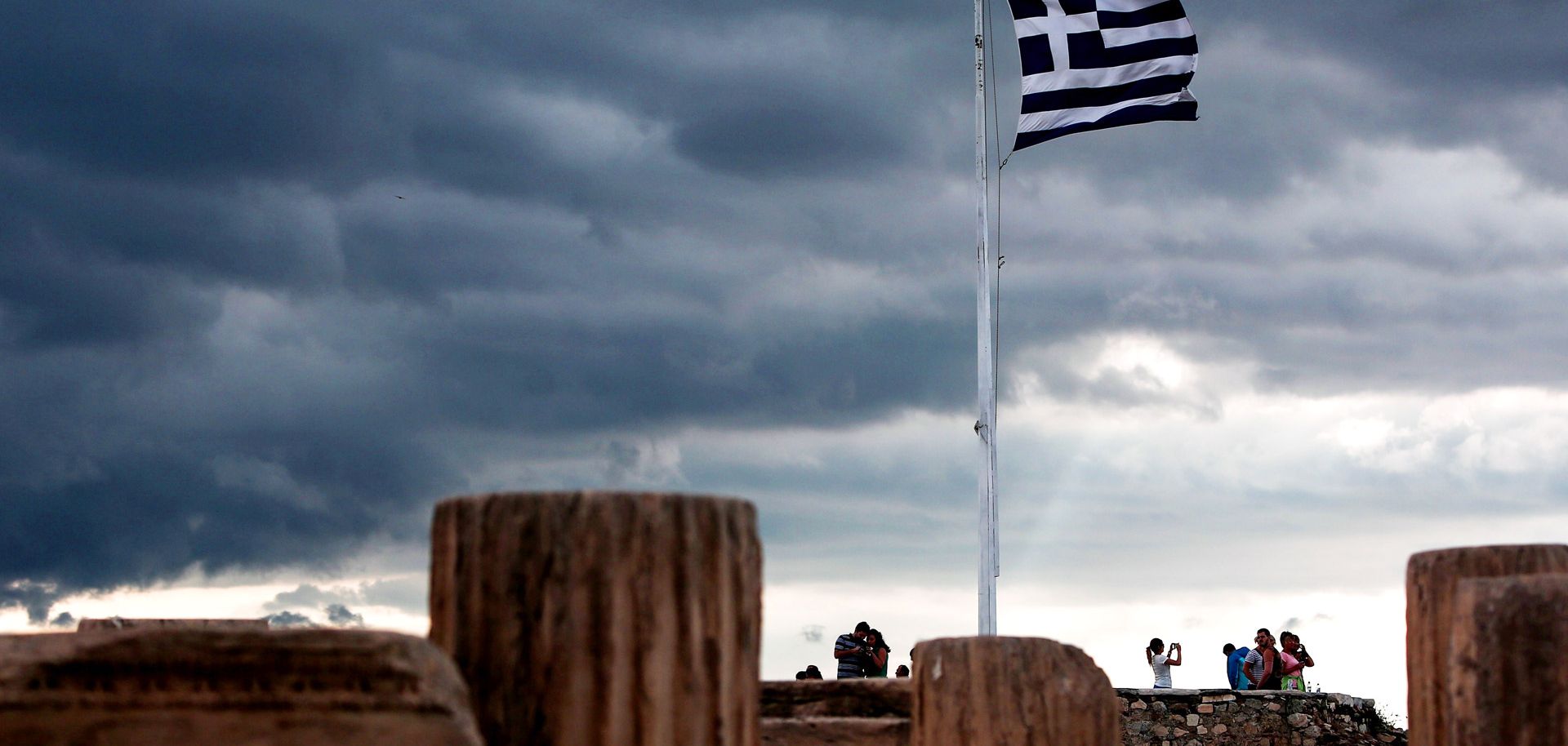 A Greek flag waves in the breeze at Acropolis hill, in Athens on June 5, 2015. 