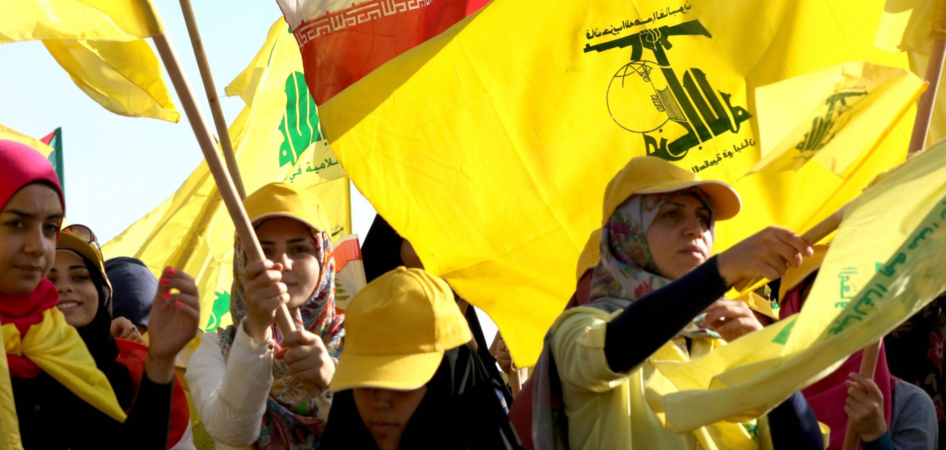 Hezbollah supporters wave the militant group's flag at a rally in Lebanon in August 2016. With its vast network of operatives scattered around the world, Hezbollah has demonstrated its ability to stage attacks in unexpected locations to further its cause.
