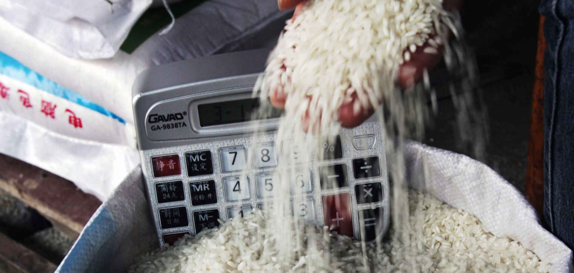 A customer checks rice at a farmers' market in Hubei Province, China.