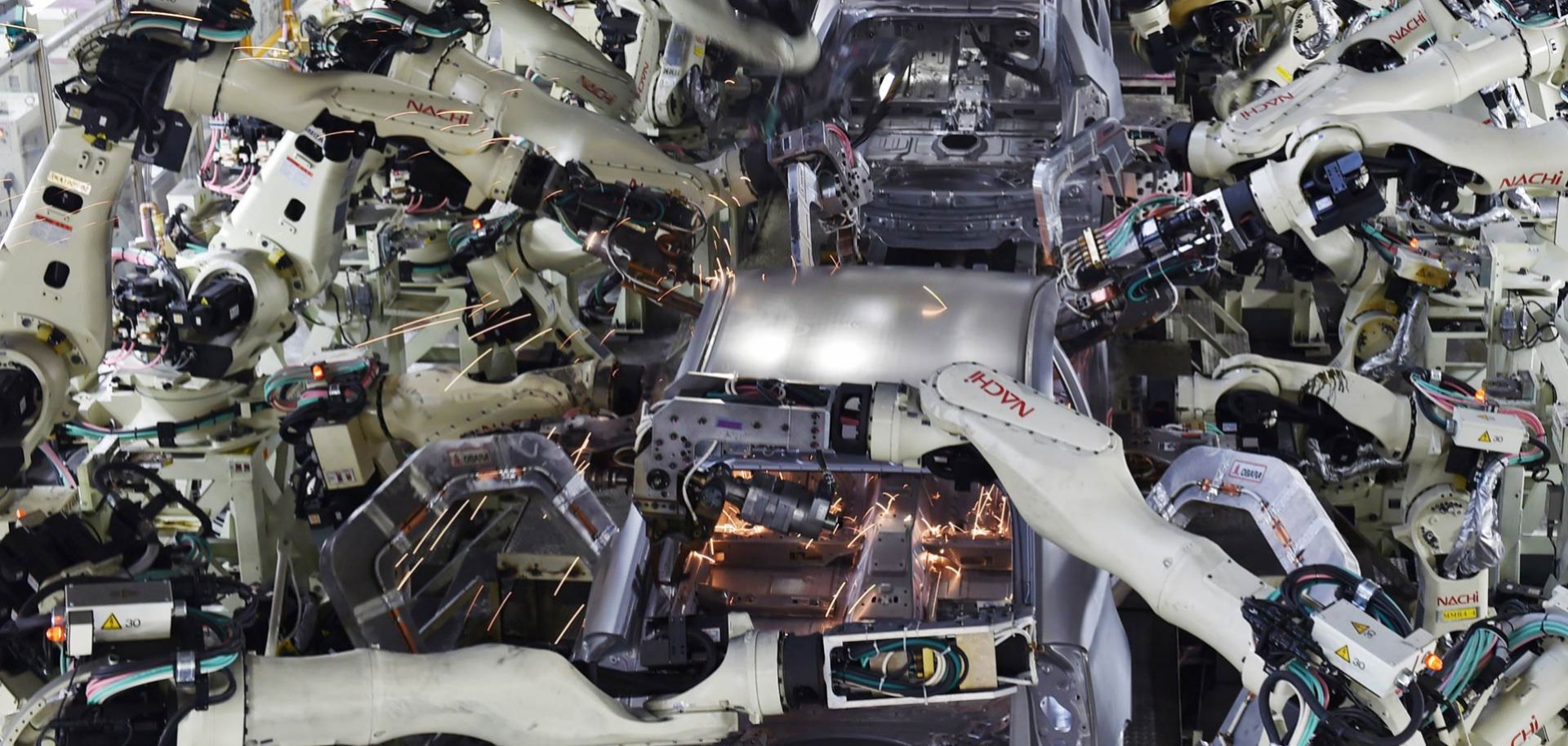 Automated welding machine robots assemble automobile bodies at Toyota Motor's Tsutsumi plant in Toyota, Japan.