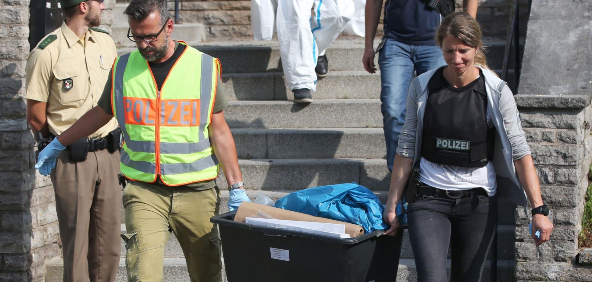 Police officers carry out evidence collected at a refugee center in Ansbach, Germany, where the migrant who was behind the country's first suicide bomb attack lived.