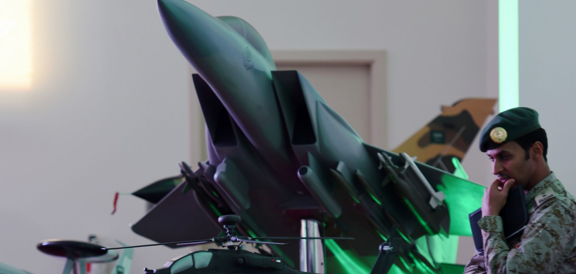 A Saudi soldier stands next to a replica fighter jet during a daily media briefing on Operation Decisive Storm.