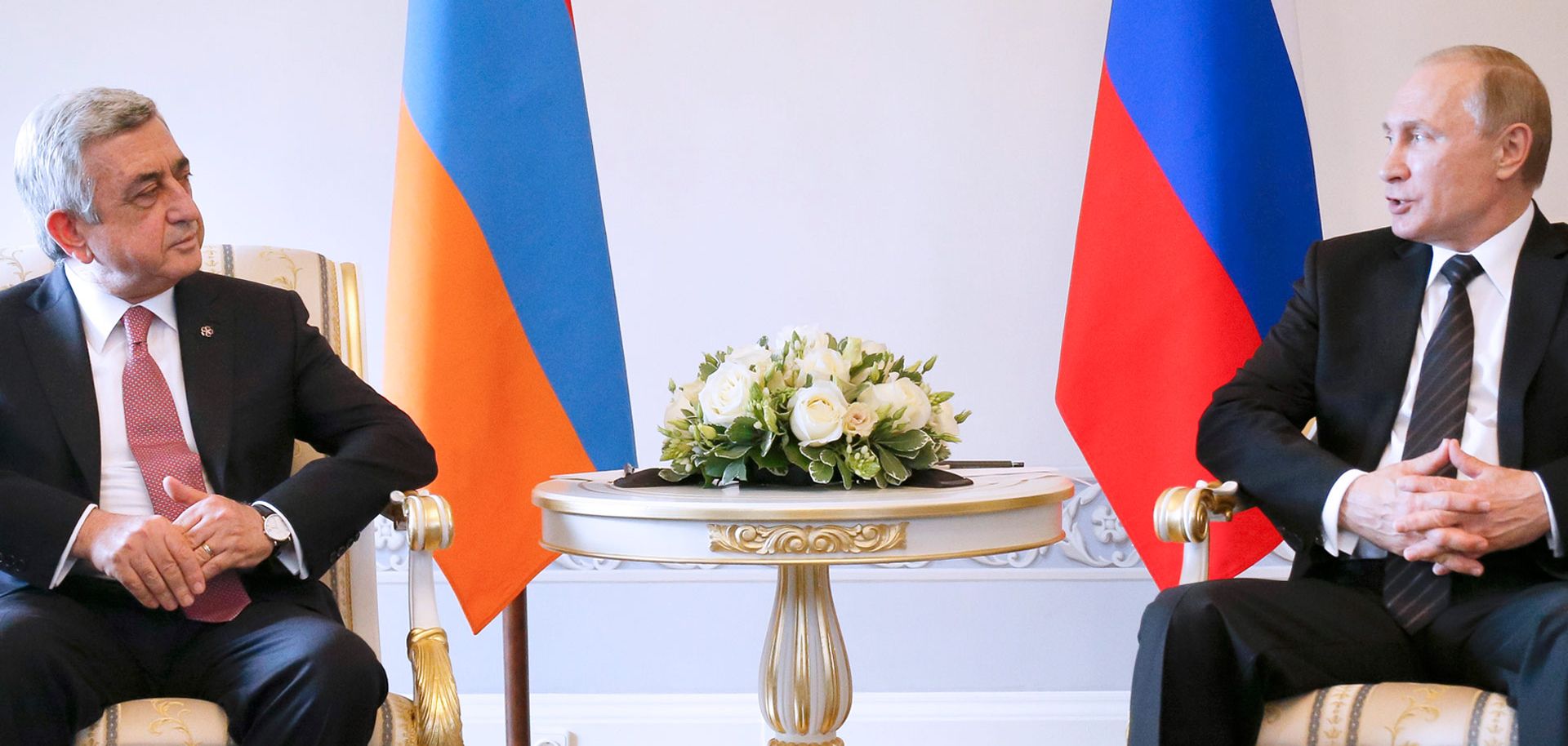 Russian President Vladimir Putin (R) mediated the latest round of talks between Armenian leader Serzh Sarkisian (L) and Azerbaijani President Ilham Aliyev on June 20 in St. Petersburg. The three met to discuss an end to the Nagorno-Karabakh conflict.
