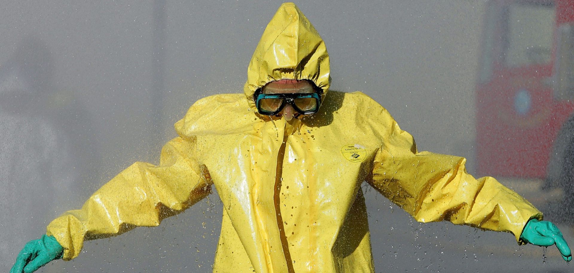 A man in a hazardous materials suit goes through a decontamination shower during a WMD training workshop in California.