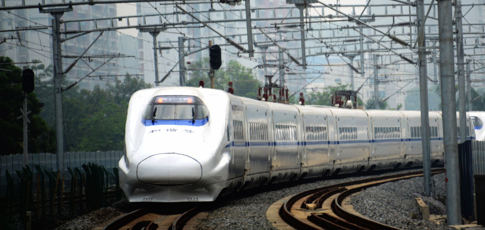 A high-speed train travels on the railway to Beijing in Nanning, southern China's Guangxi province on June 13, 2014.