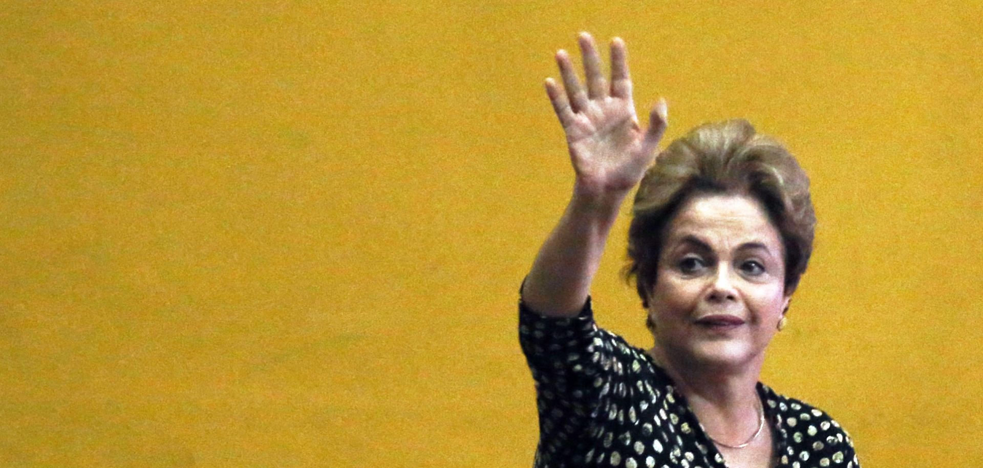 Brazil's embattled president, Dilma Rousseff, waves as she enters a conference in Brasilia on May 10. 