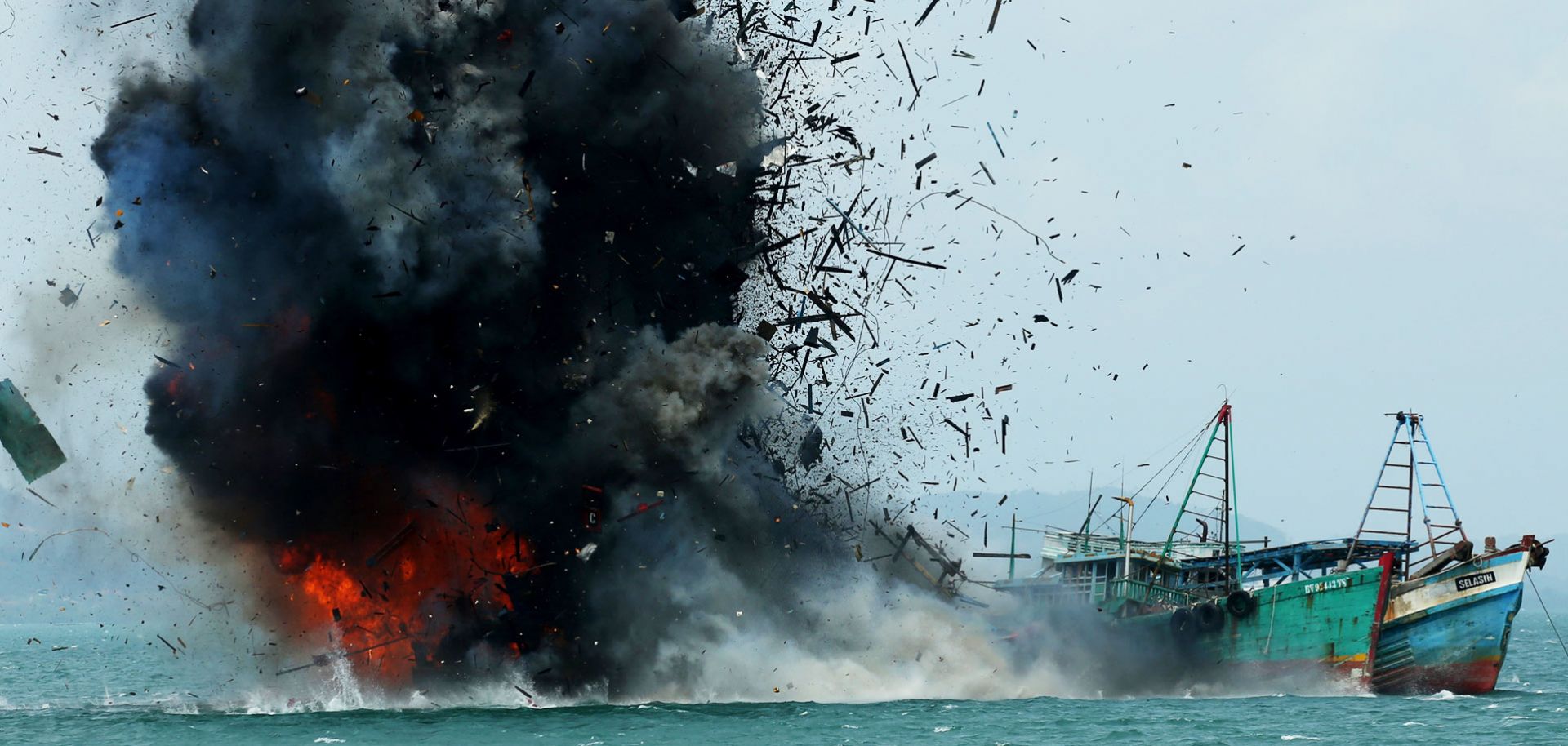 The Indonesian government blows up a foreign fishing vessel in its waters earlier this year. 
