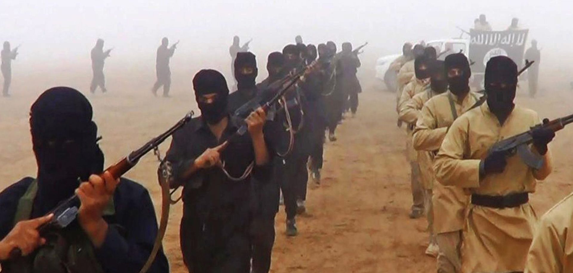 Islamic State militants march with weapons in a propaganda video. (Islamic State)