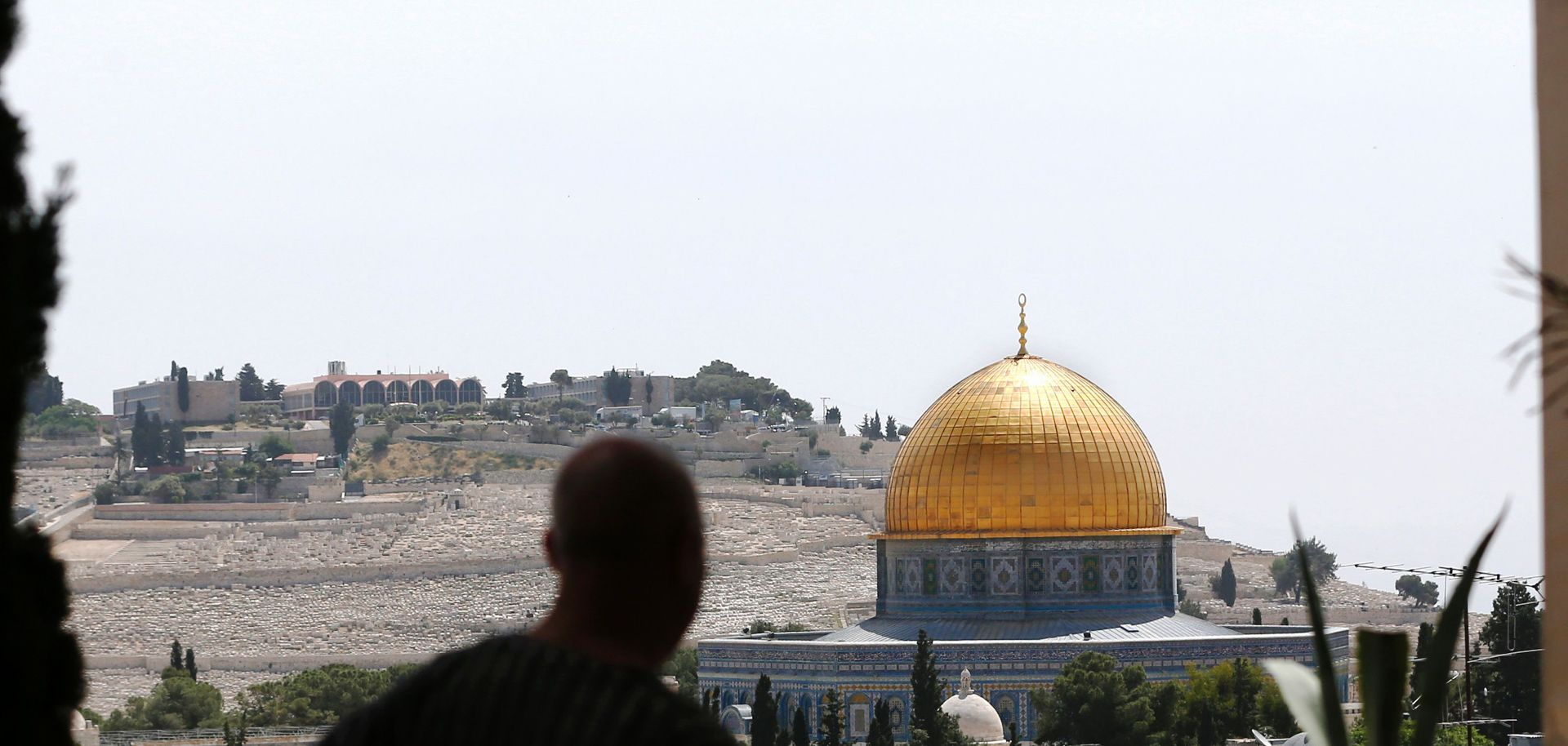 A man looks toward the Dome of the Rock and al-Aqsa mosque compound in Jerusalem on April 24.