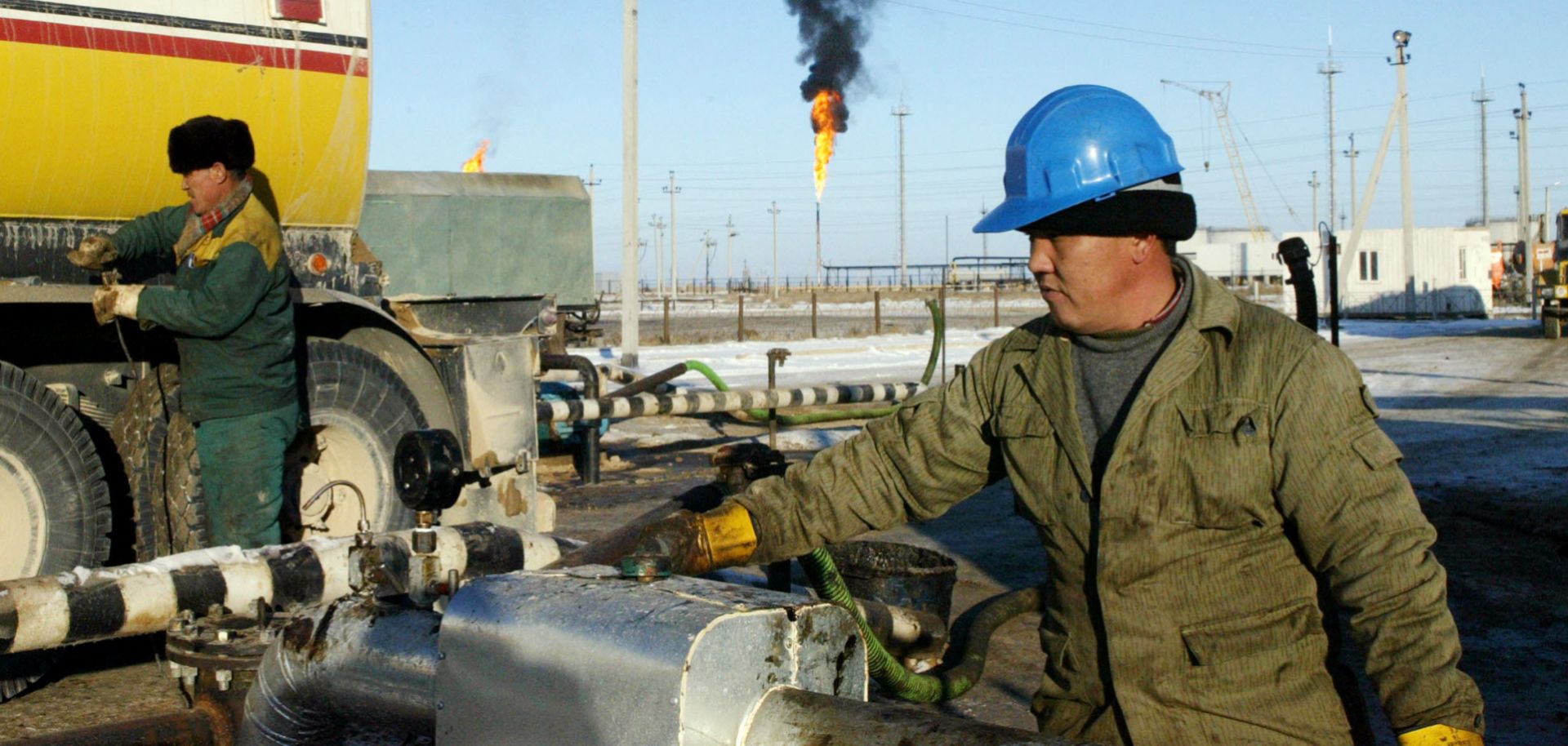 A Kazakh worker unloads oil at a terminal.