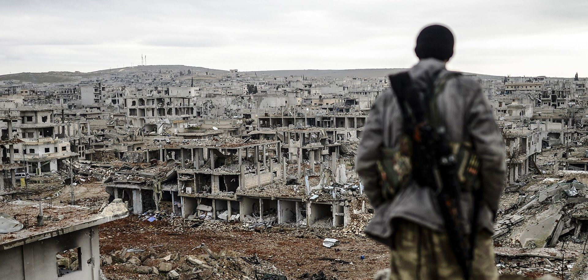 A Kurdish marksman stands on top of a building in the Syrian town of Kobani in January 2015. (BULENT KILIC/AFP/Getty Images)
