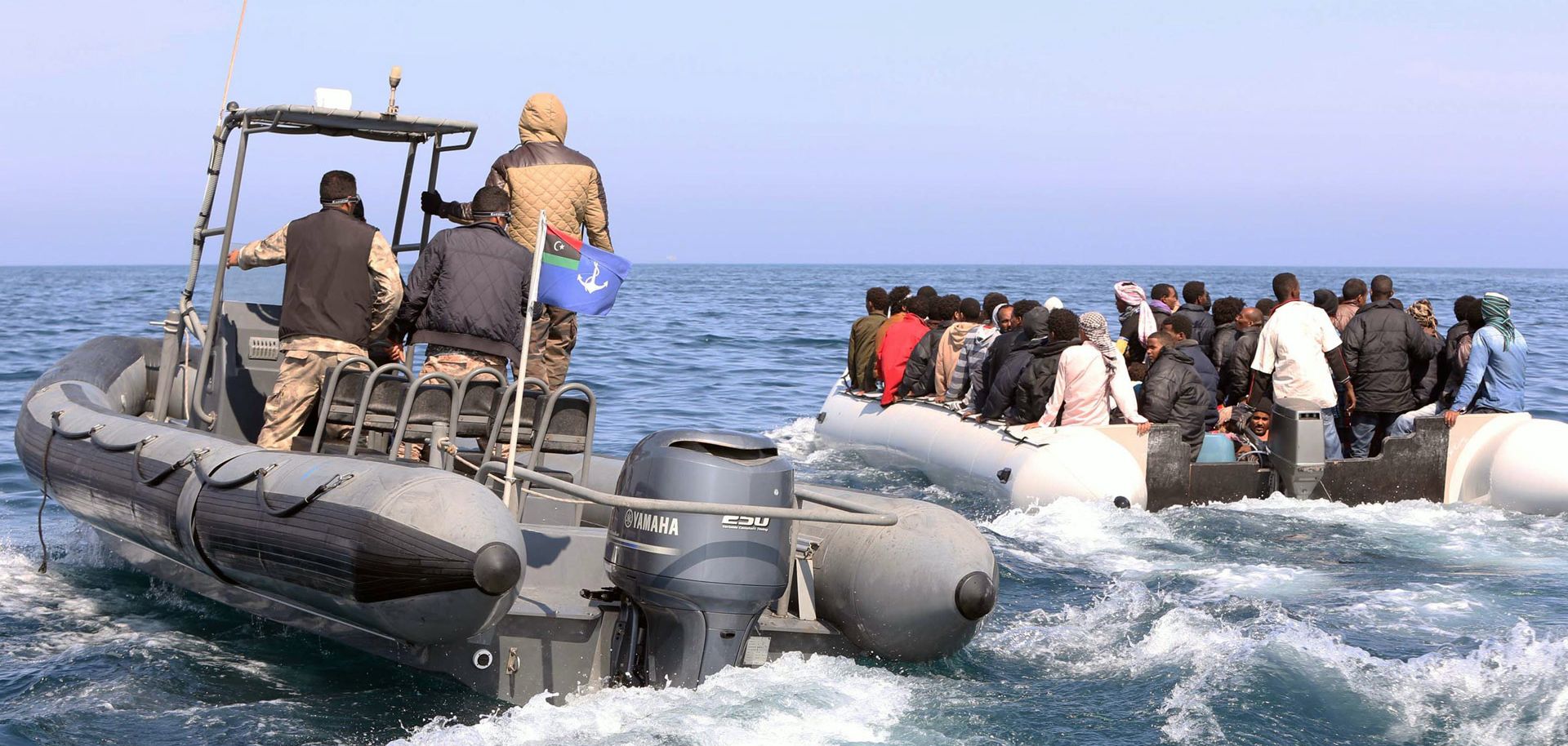 Libyan coast guard vessels detain a boat carrying migrants hoping to enter Europe illegally.