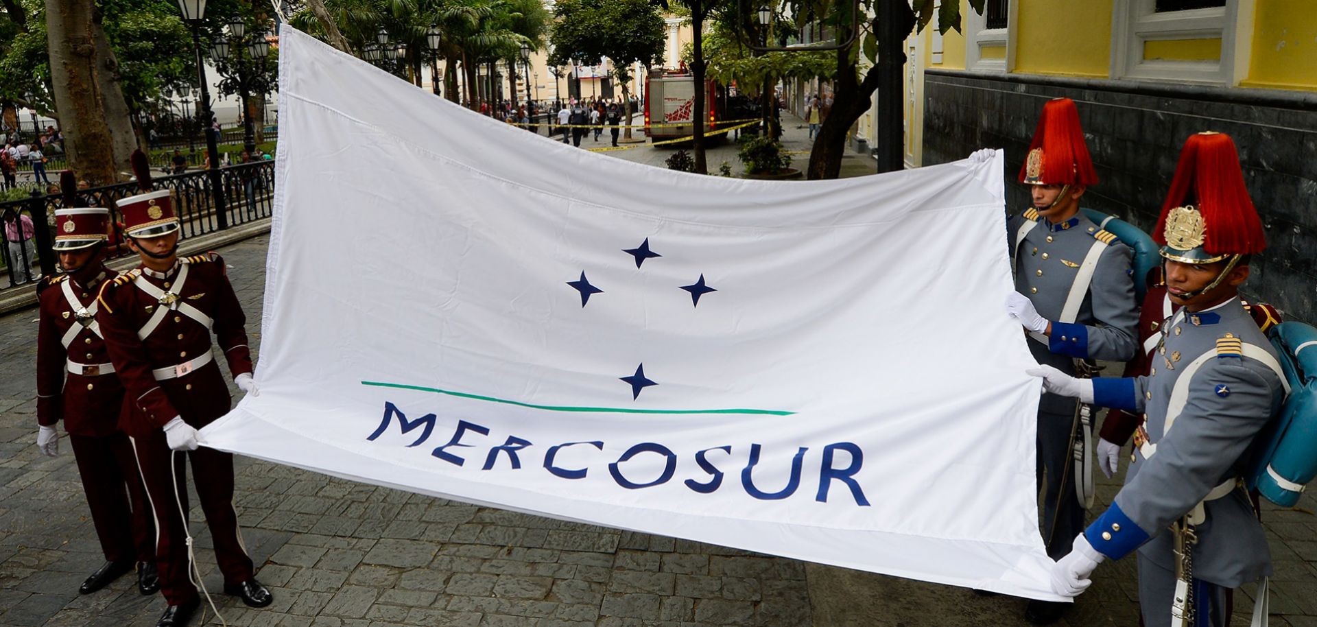 Personnel raise the Mercosur flag in Caracas on Aug. 5. Expelling Venezuela from the trade bloc may not be as easy as its opponents suggest.