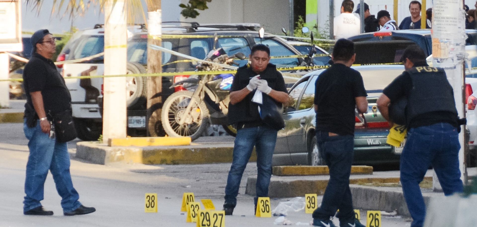 Investigators work a crime scene in Cancun, Mexico, where a gunfight erupted on Jan. 17.