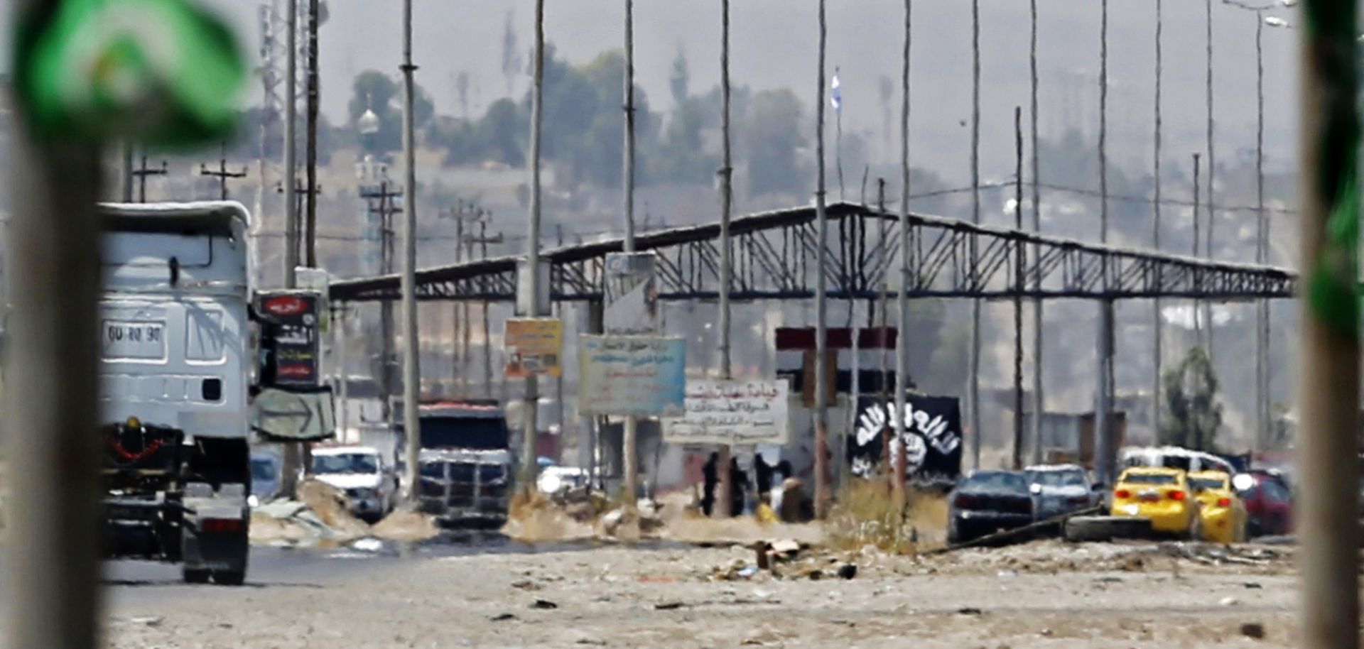 Islamic State militants hold a checkpoint in Mosul on June 16, 2014.