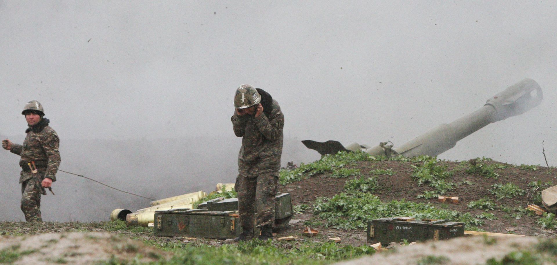 Armenian soldiers belonging to Nagorno-Karabakh's army fire an artillery shell toward Azerbaijani forces on April 3.