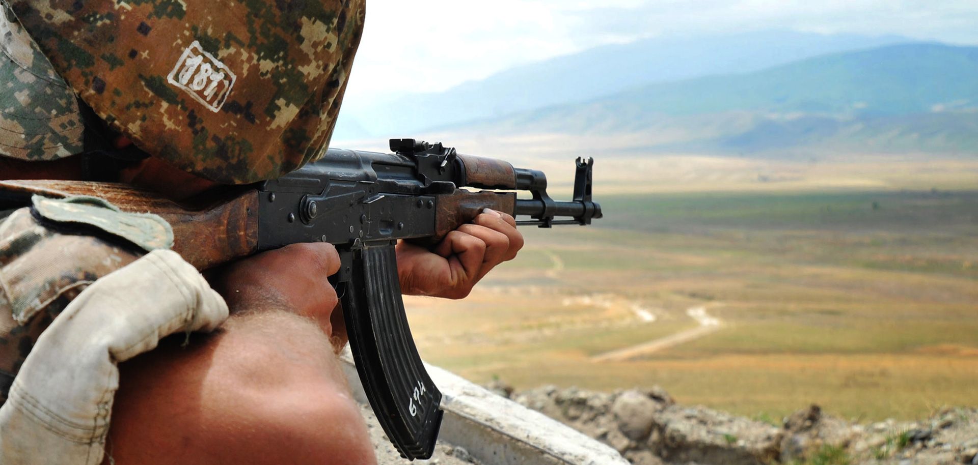 An Armenian soldier of the self-proclaimed republic of Nagorno-Karabakh aims his rifle as he stands in a trench at the frontline on the border with Azerbaijan near the town of Martakert, on July 6, 2012.