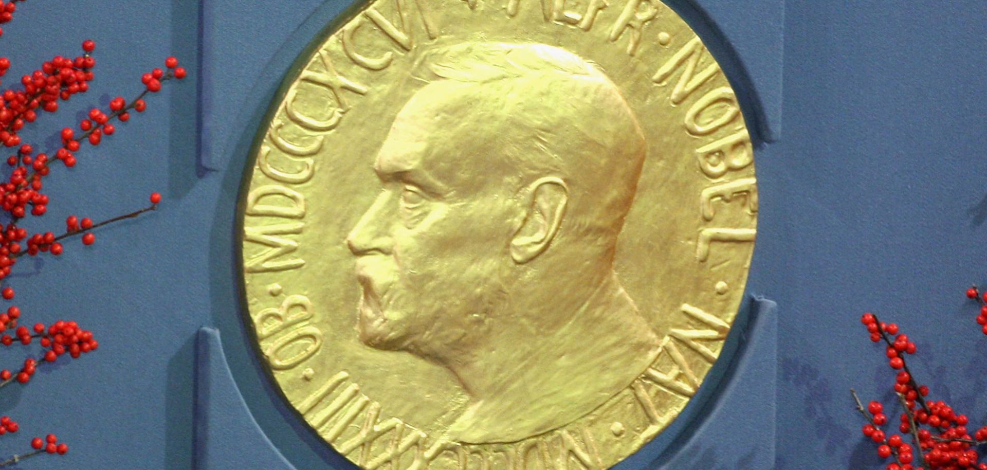 A plaque of Alfred Nobel is displayed at the 2008 Nobel Peace Prize ceremony. Receiving the Nobel Prize is considered the pinnacle of many scientists', economists' and humanitarians' careers, recognizing significant discoveries. These tend to have lasting geopolitical consequences.