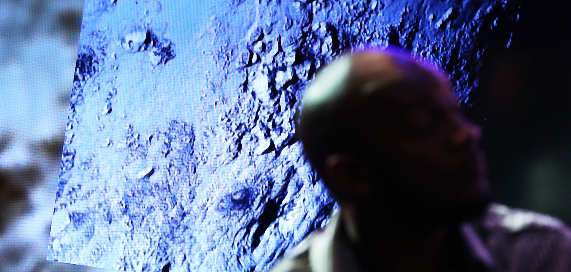 An image from the New Horizons spacecraft, which passed within 7,800 miles of Pluto July 14, is shown during a NASA news conference July 15.