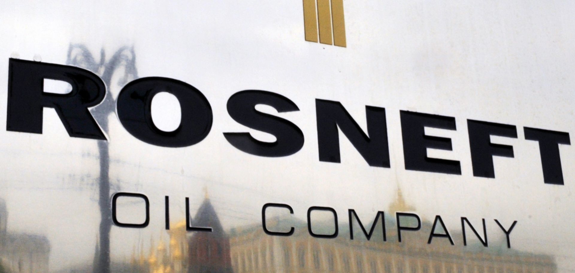 The Kremlin is reflected in the company plate of the state-controlled Russian oil giant Rosneft at the entrance of its Moscow headquarters.
