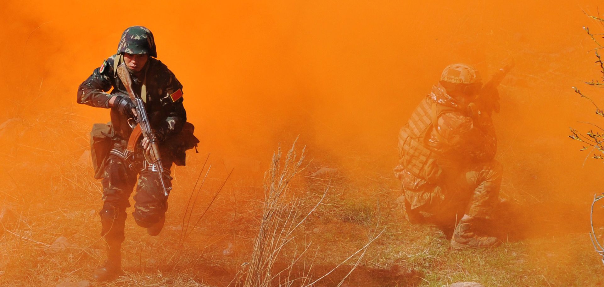 Soldiers run through smoke during joint military exercises in Kyrgyzstan involving participants from the Shanghai Cooperation Organization (SCO) member states, April 24.
