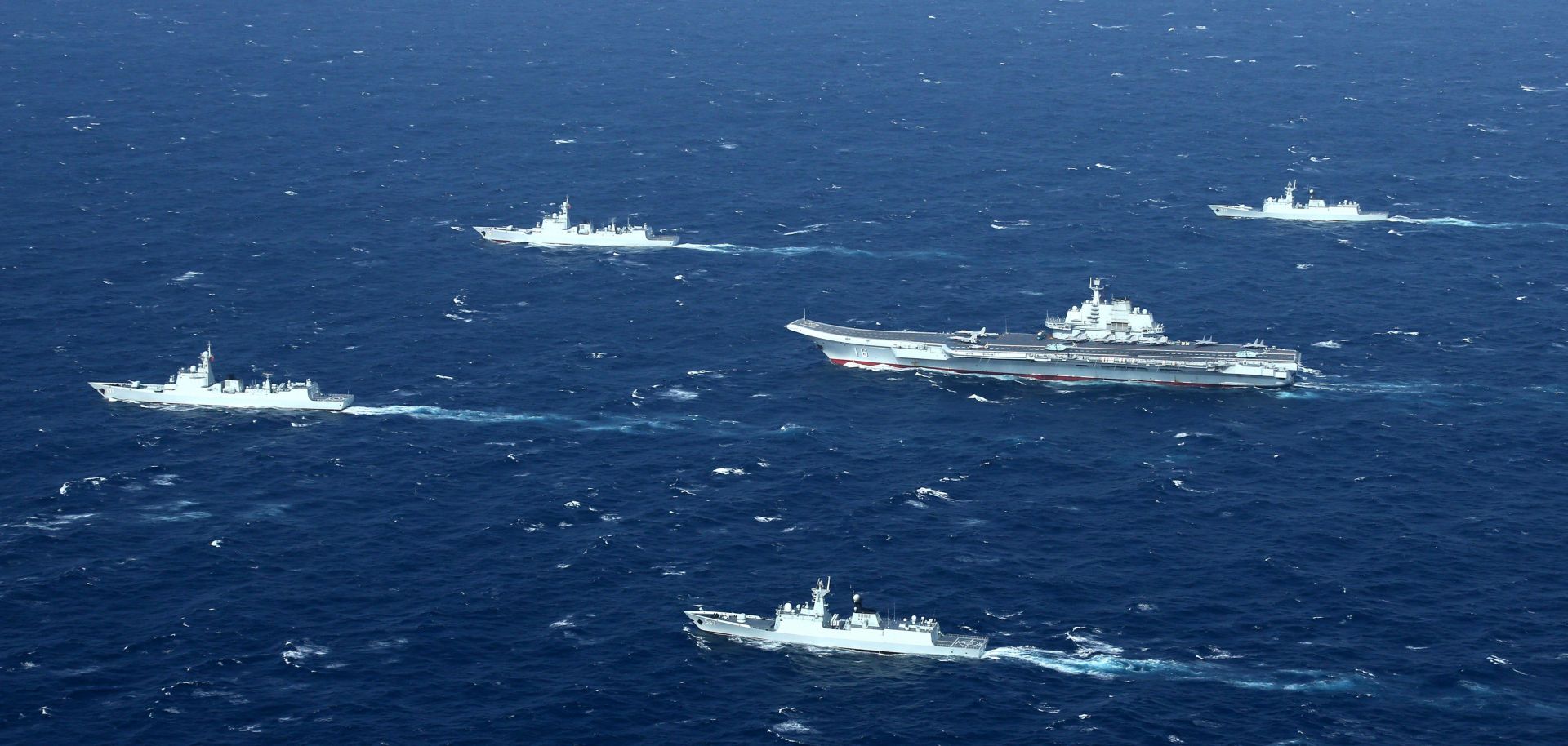 A Chinese navy formation, including the aircraft carrier Liaoning (C), steams ahead during military drills in the South China Sea early in 2017.