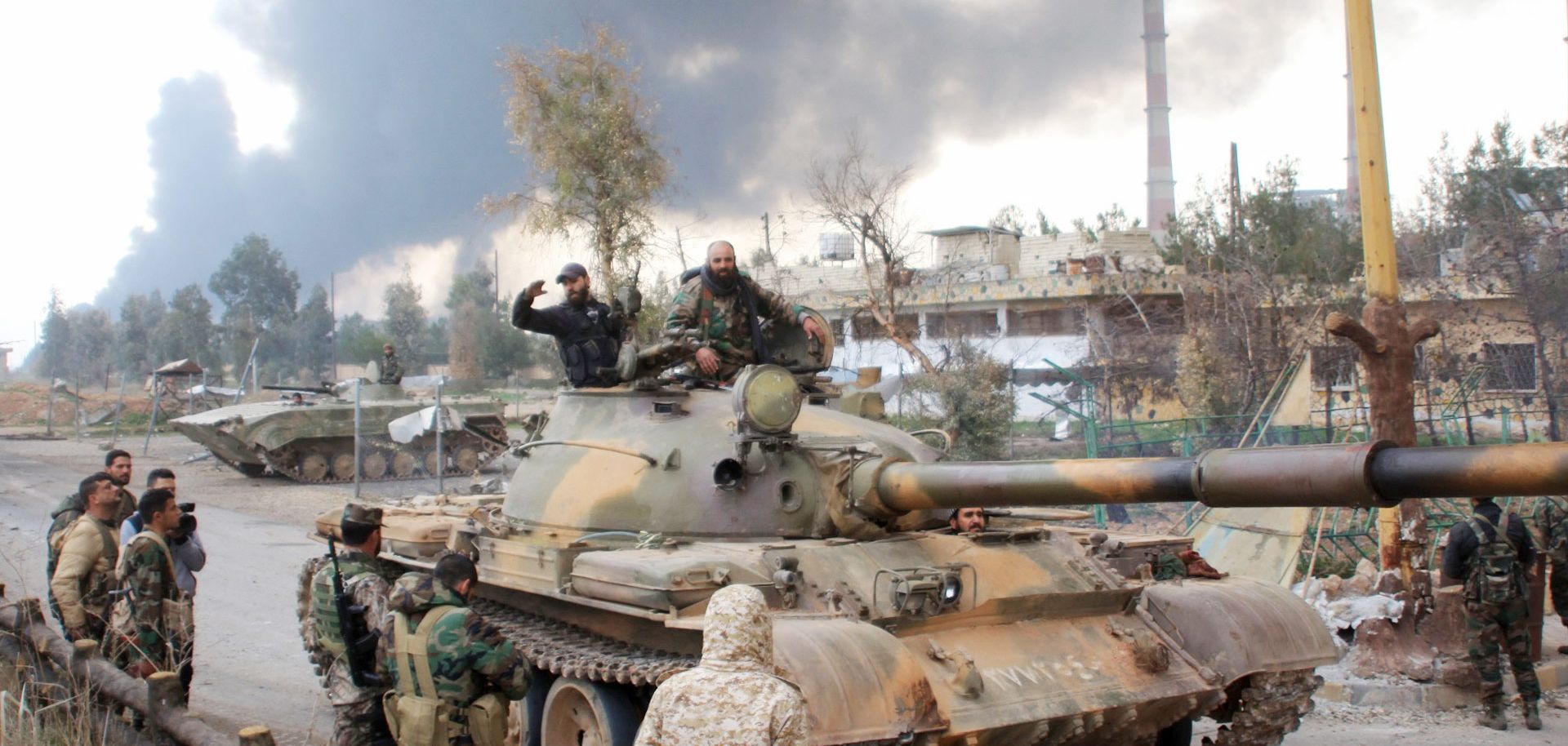 Syrian government forces patrol near Aleppo's thermal power plant after they took control of the area on the eastern outskirts of Syria's northern embattled city from Islamic State (IS) group fighters on February 21, 2016. In two days Syrian government forces have taken more than a dozen villages from IS jihadists around a stretch of highway that runs east from the northern city of Aleppo to the Kweyris military base. / AFP / GEORGE OURFALIAN (Photo credit should read GEORGE OURFALIAN/AFP/Getty Images)