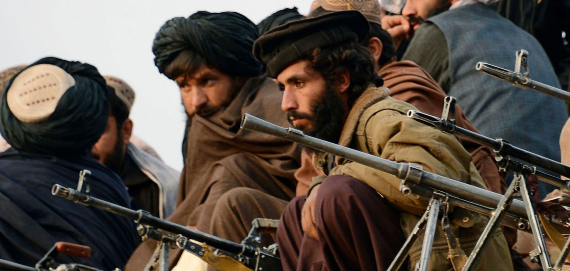 Afghan Taliban fighters listen to Mullah Mohammad Rasool Akhund (unseen), the newly appointed leader of a breakaway faction of the Taliban, at Bakwa in the western province of Farah, Nov. 3. 