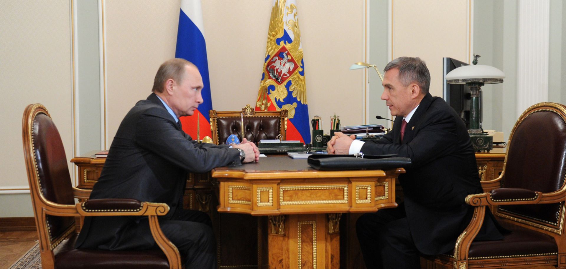 Russian President Vladimir Putin (L) can respond one of two ways to criticism from Rustam Minnikhanov, the leader of Tatarstan: Offer the republic financial concessions or purge the popular outspoken critic of his administration.