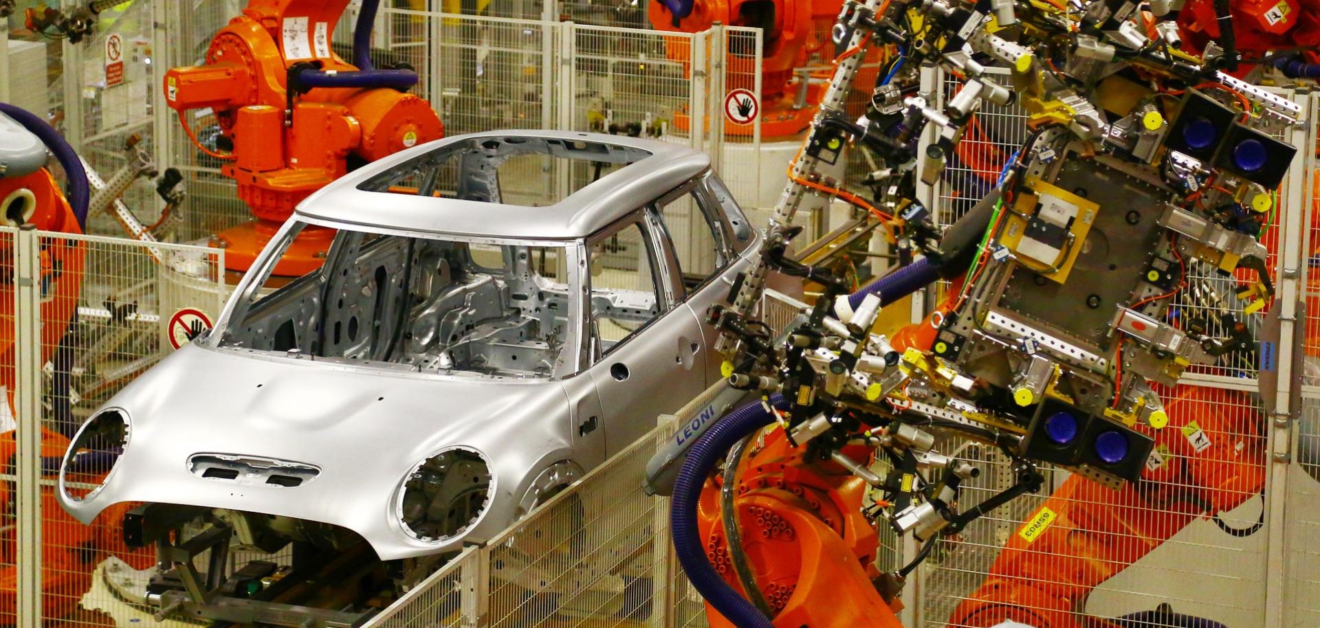 BMW mini cars pass through a robotic assembly line at a plant in Oxford on Jan. 17.