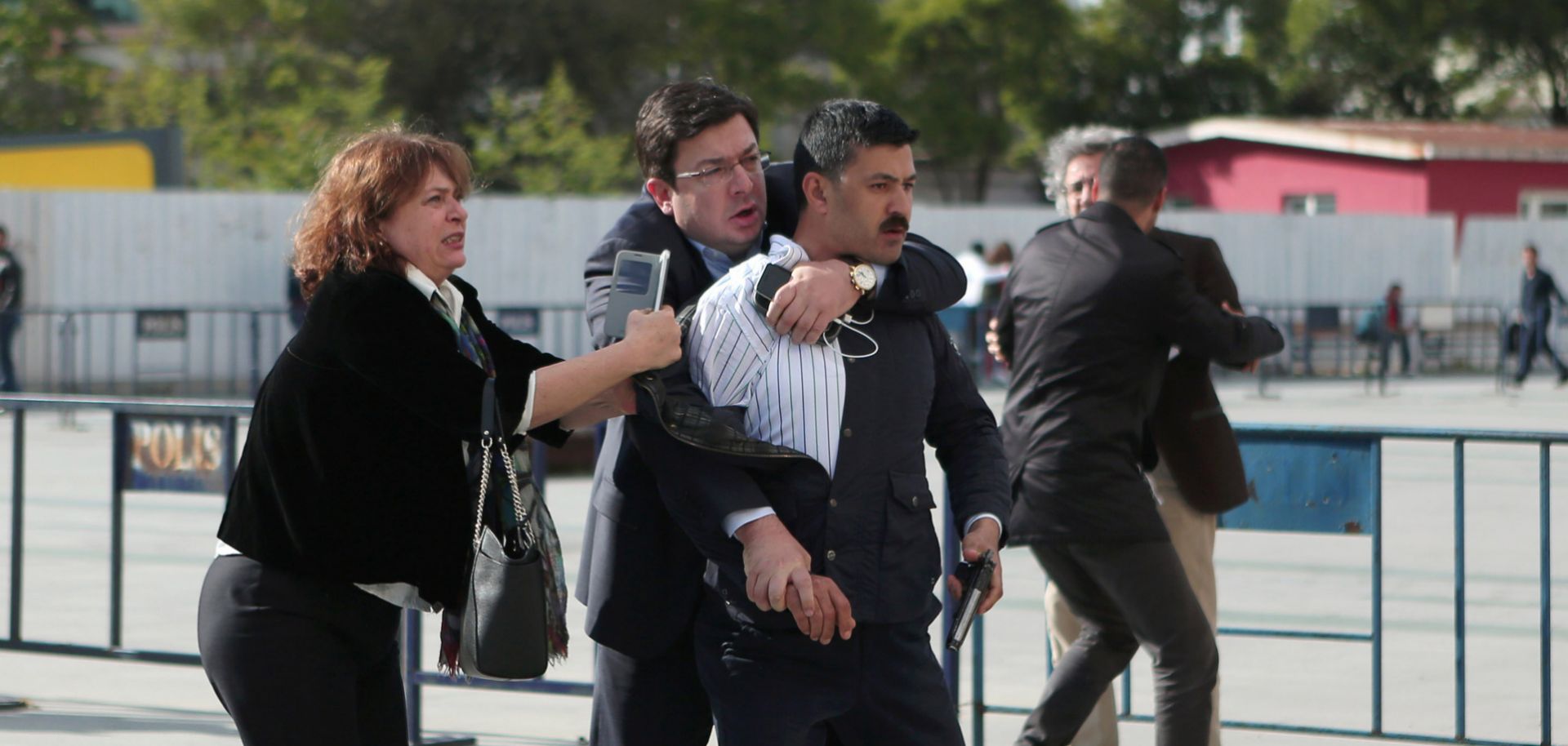 Dilek Dundar helps to restrain Murat Sahin, who attempted to shoot her husband, Turkish journalist Can Dundar, on May 6 in Istanbul, Turkey.