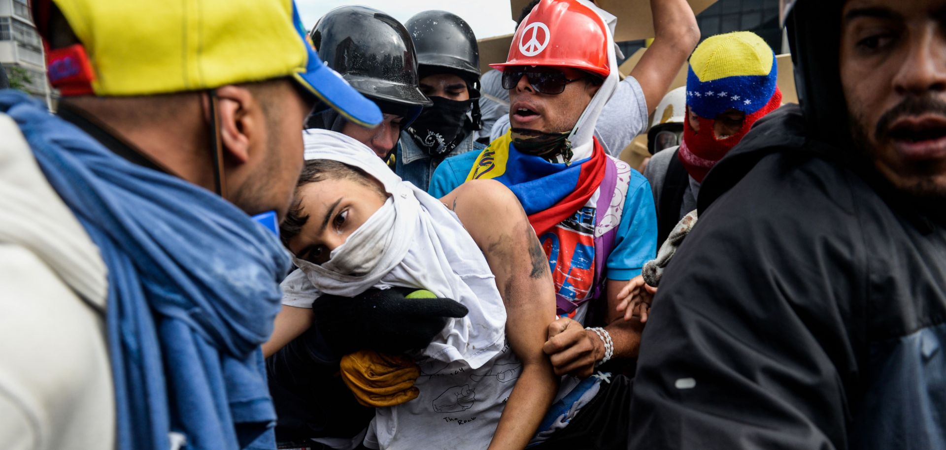 Protesters help a demonstrator who was run over by a National Guard vehicle during a protest against Venezuelan President Nicolas Maduro, whose government is desperately clinging to power.