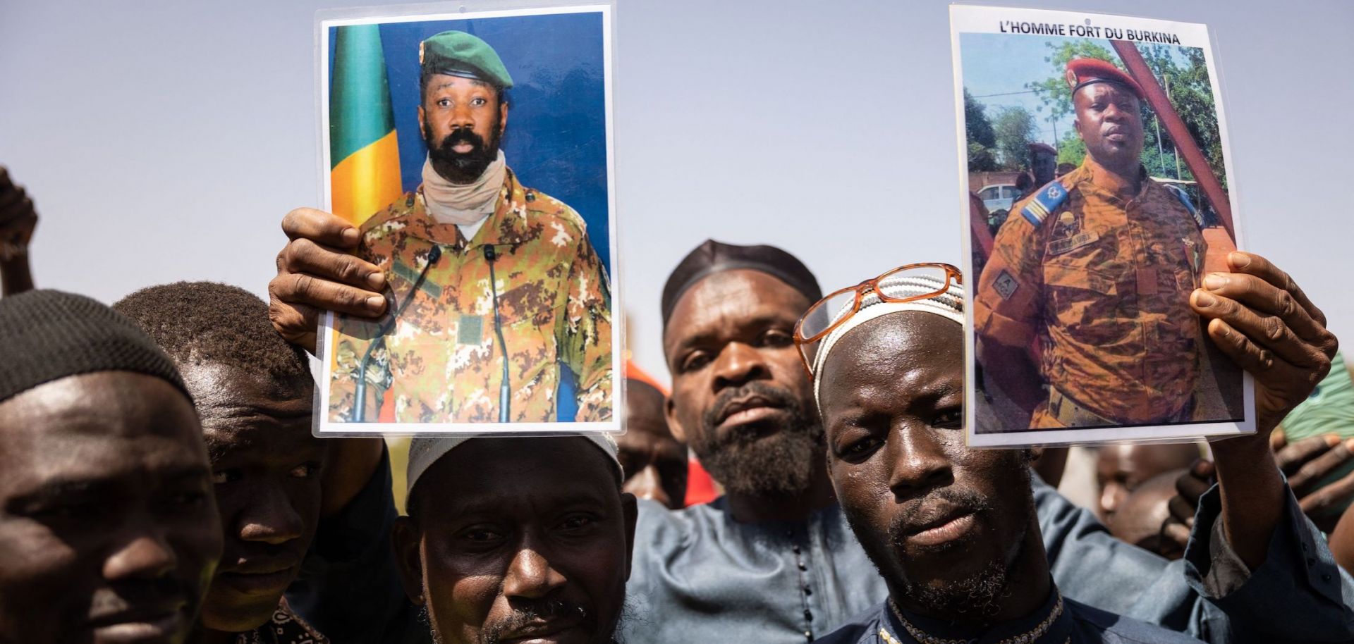 Demonstrators in Ouagadougou, Burkina Faso, hold up photos of Malian coup leader Assimi Goita (who seized power in Mali for the second time in a May 2021 coup) and Burkina Faso coup leader Paul-Henri Sandaogo Damiba on Jan. 25, 2022.
