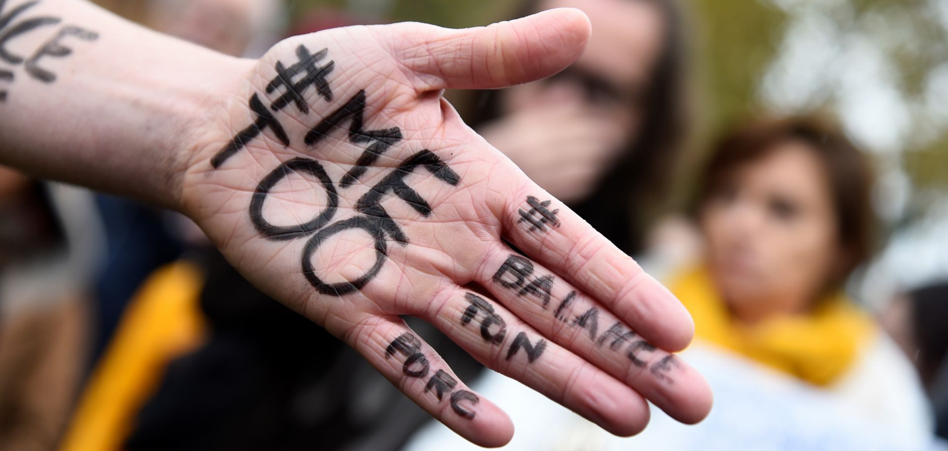 A protester brandishes the slogans "#ME TOO" and "#SQUEAL ON YOUR PIG" at a demonstration in Paris against sexual harassment and assault.