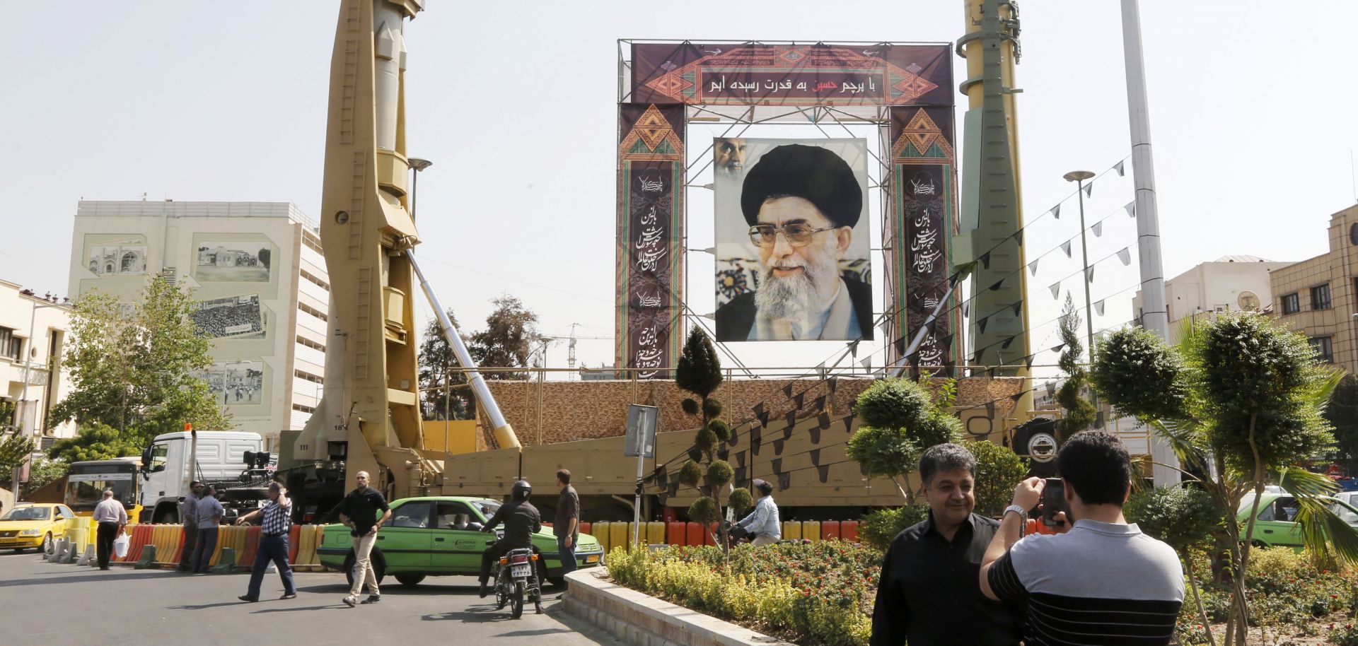 Medium-range ballistic missiles stand next to a portrait of Iranian Supreme Leader Ayatollah Ali Khamenei in Tehran on Sept. 25, 2017, during commemorations marking the anniversary of the 1980s Iran-Iraq war.