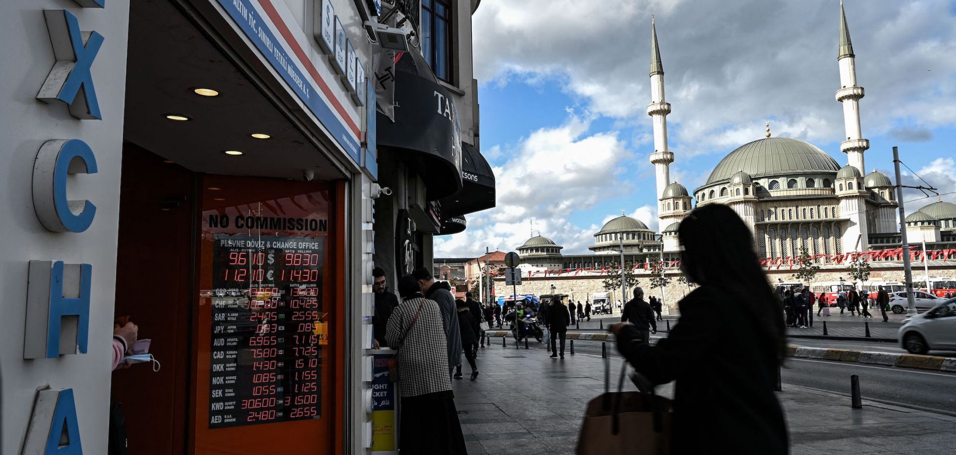 Customers wait outside a currency exchange agency in Istanbul